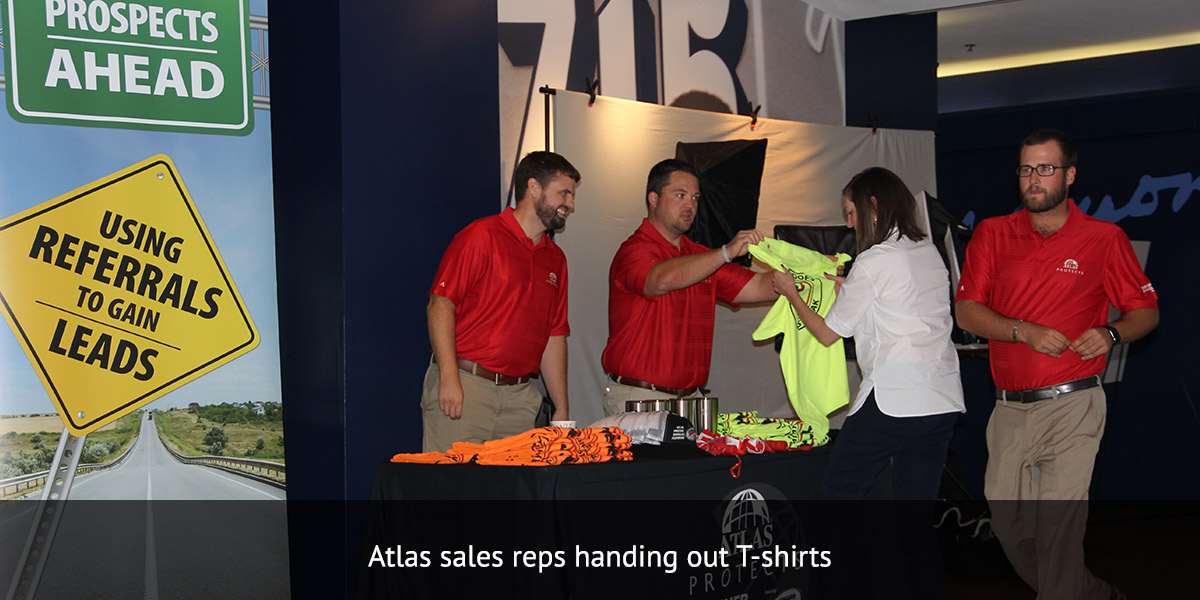 Atlas Roofing sales reps handing out T-shirts