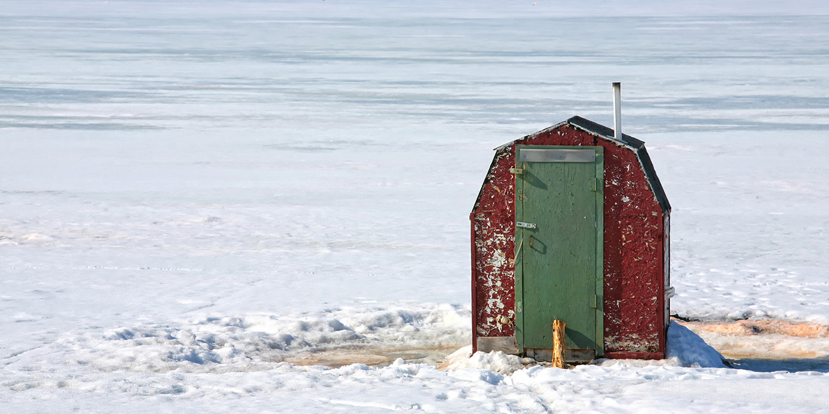 ice fishing shack on lake